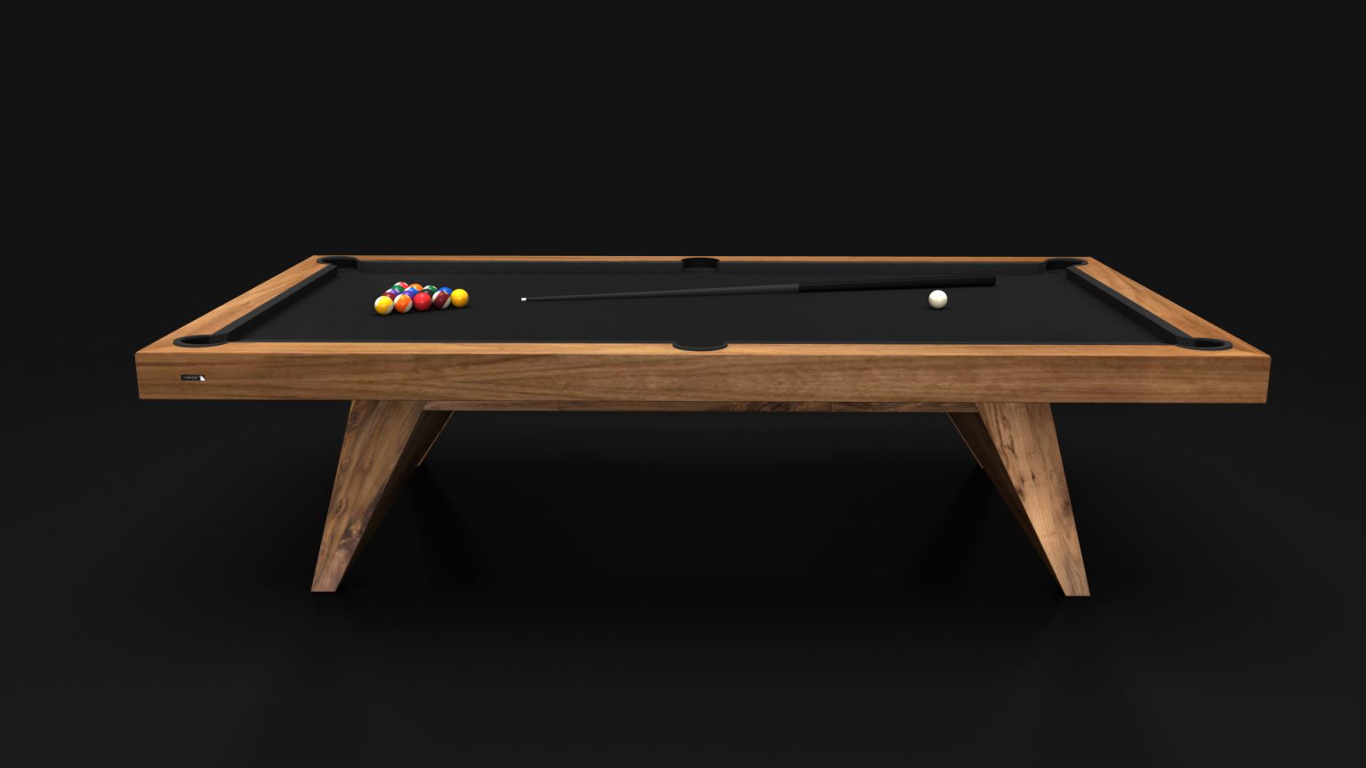 The luxury Trigon Pool Table, boasting a sleek black top, stands out in the dim light. A triangle of colorful billiard balls and a cue stick are arranged perfectly, highlighting the table’s elegant design against the dark backdrop.