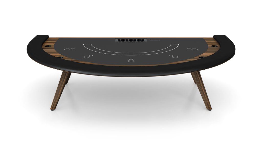 The Hamptons Blackjack Table is a semi-circular luxury design featuring a dark felt top, wooden legs, card markings, chip placements, and a smooth black border for armrests.