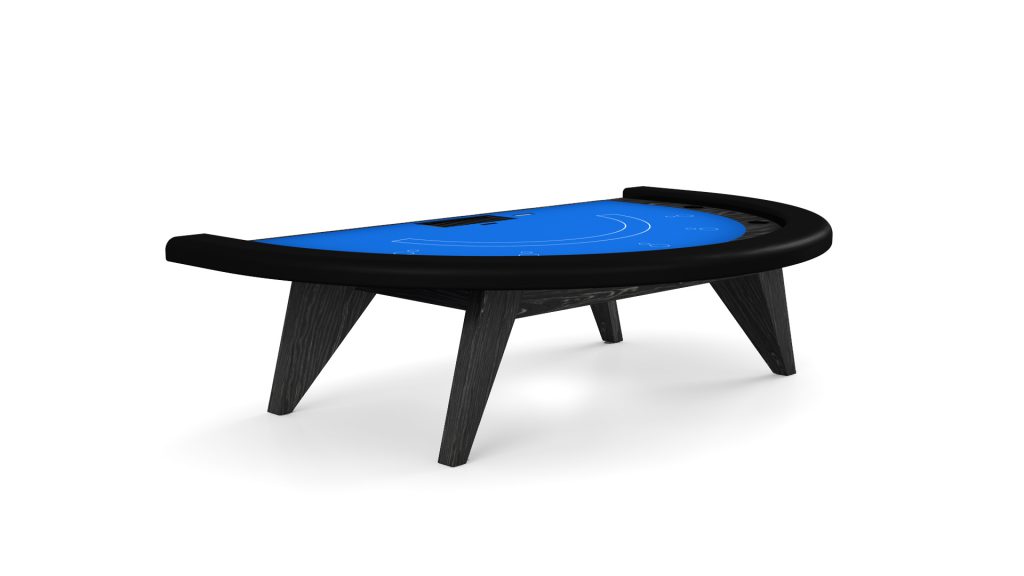 The Trigon Blackjack Table boasts a modern design with a blue felt surface and black trim, elegantly supported by sleek black wooden legs, making it perfect for elevating any gaming space against a plain white background.