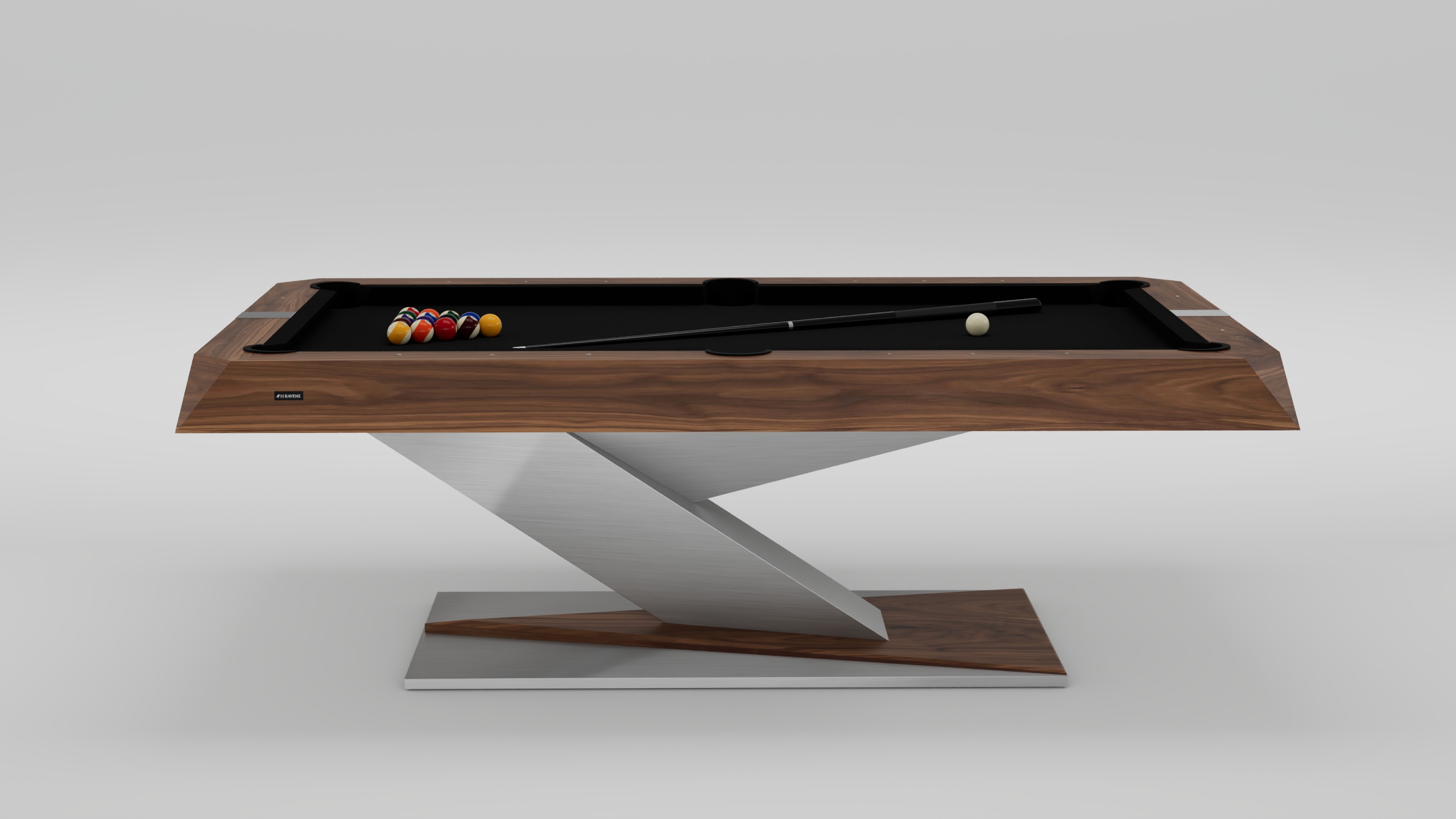 The Mitchell Pool Table features a sleek wooden top, black felt surface, and an angular metal base. It comes with a cue stick, cue ball, and a racked set of billiard balls arranged on the table.