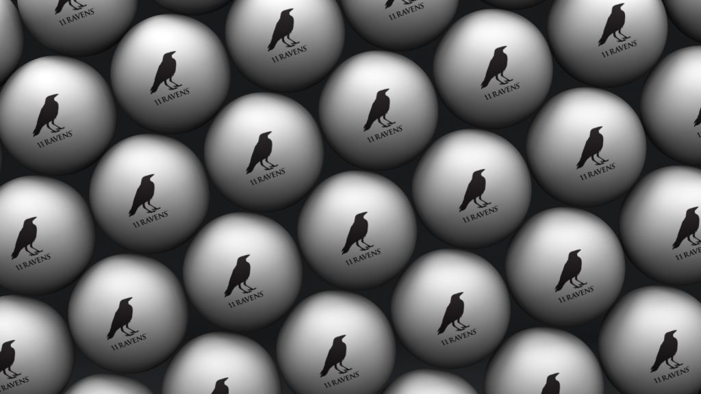 The 11R T-T Balls are luxury items resembling opulent ping pong balls, styled with a gray egg pattern featuring a black raven silhouette and the word RAVENS. When arranged closely, they form a seamless repeated design.