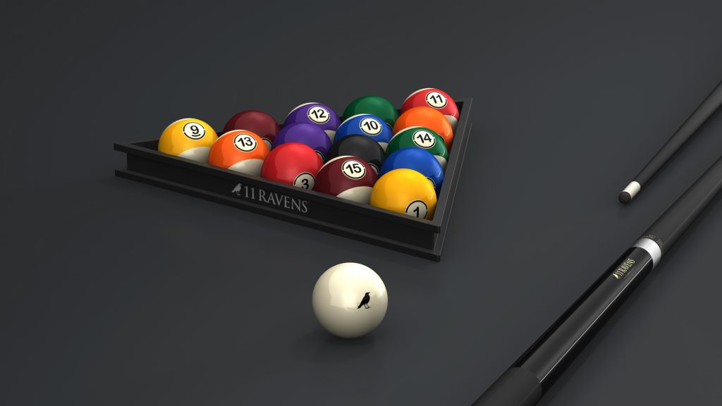 The 11R Triangle Table showcases a racked set of colored billiard balls with a luxury pool triangle, a cue ball in the foreground, and two cues on the right. The ball rack is elegantly labeled 11 Ravens.