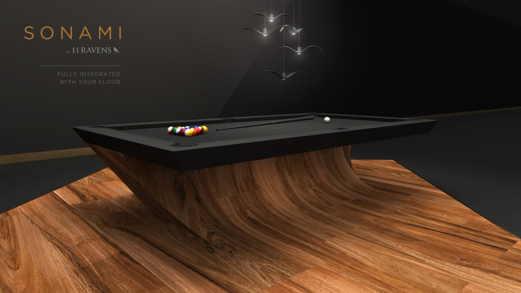 The Sonami Table exemplifies a luxury game table with its sleek wooden base and dark playing surface on a matching floor. A triangle of colorful balls is ready with a white ball nearby, all under elegant overhead lighting.