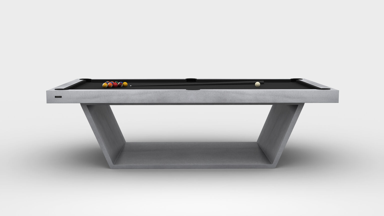 The Mesa Pool Table features a modern design with a sleek black playing surface and geometric concrete base, reflecting the sophistication of luxury game tables. Pool balls are arranged at one end, and a white cue ball stands out against a plain light gray background.