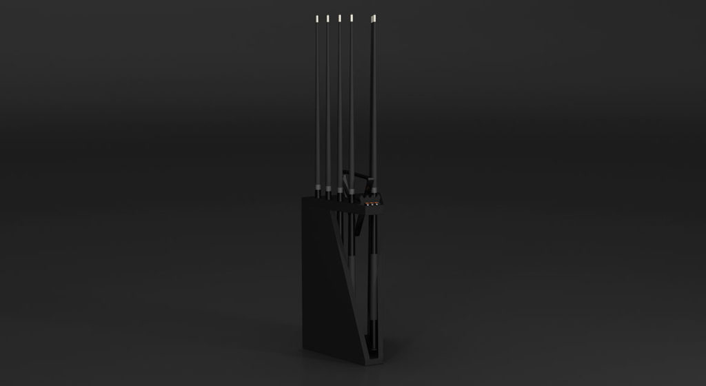 A sleek black electronic device, reminiscent of the elegant Luxury Spartan Cue Rack, highlights its minimalist design with four slender rods on a rectangular base against a dark background. This modern piece, known as Spartan Cue Rack - Quick Ship, is available to enhance your space swiftly.