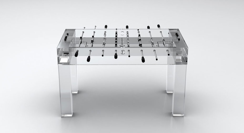 The Malibu Lucite Foosball Table features transparent legs, sleek black handles, and a minimalist design with visible rods and players, creating a modern and sophisticated look against a plain white background.