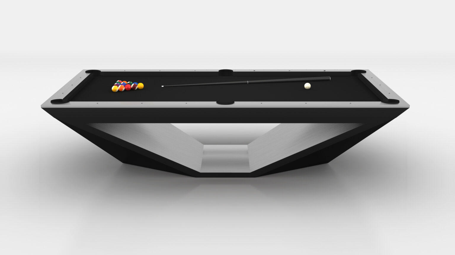 The Stealth Pool Table boasts a modern, angular design in black and silver, exuding luxury. It features racked balls at one end, a cue stick elegantly resting across the surface, and a single cue ball positioned near the opposite end.