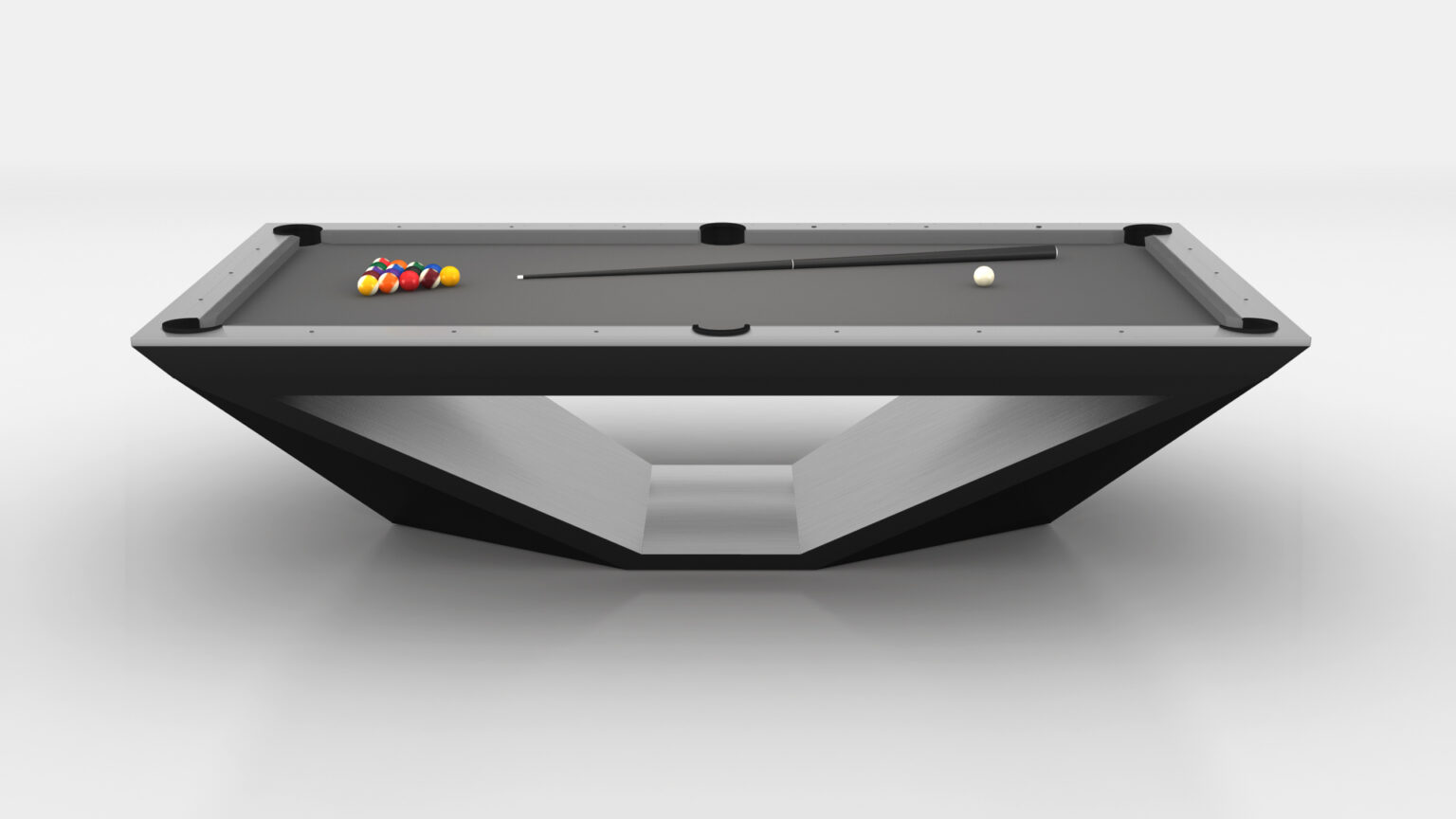 The Stealth Pool Table, with its modern black design and unique V-shaped base, exudes luxury. Its gray surface showcases a neatly arranged billiard ball set, a cue stick, and a white cue ball, all against a minimalist white background.