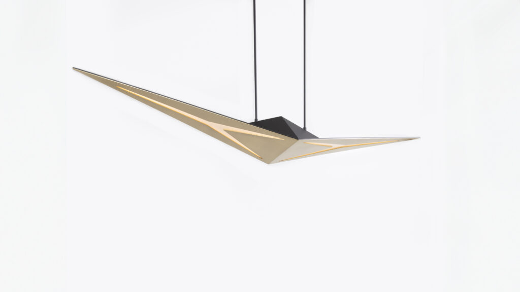 The Áves Pendant Light boasts a futuristic design with sharp, angular features in gold and black, reminiscent of luxury game tables. Its geometric shapes offer an elegant and modern look against a plain white background.
