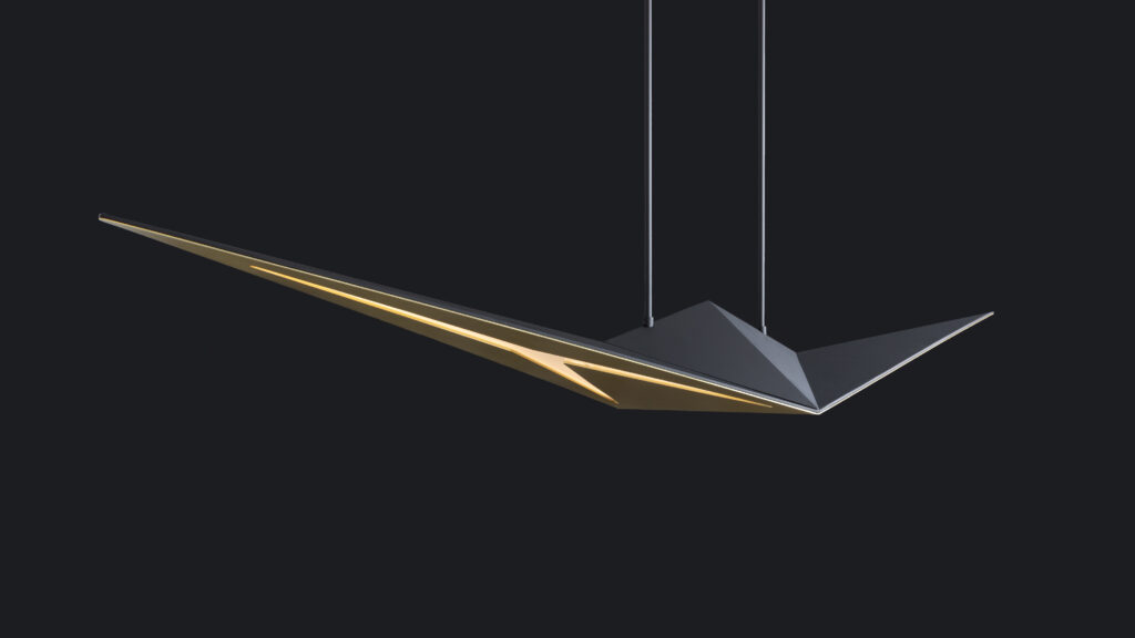 The Áves Pendant Light, featuring sharp geometric lines and a dark matte finish, hangs against a black backdrop. Similar to luxury game tables enhancing any space, its interior casts a warm golden glow highlighting its sleek design.