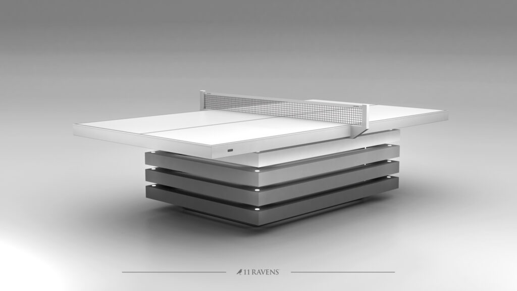 The Arclight Ping Pong Table features a minimalist design with a luxury white playing surface and a metal net, supported by horizontal metallic layers and set against soft gray tones.