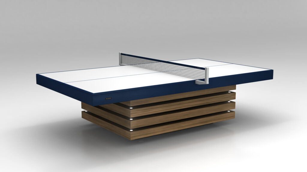 The Arclight Ping Pong Table, with a sleek white top and navy edges, features a metal net and a base of stacked horizontal wooden panels. Its modern design complements a minimalist space with a gray backdrop.