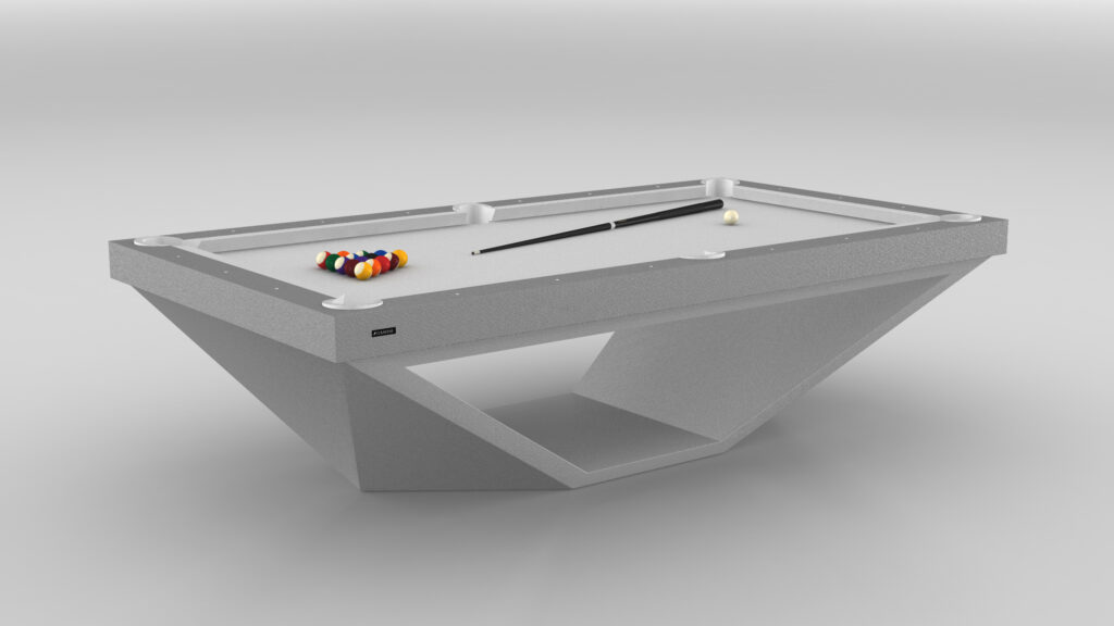 The Stealth Pool Table - Outdoor, featuring a sleek geometric base design, stands in a minimalistic space epitomizing luxury. This modern table showcases a billiard cue, a white cue ball, and an orderly set of colored balls.