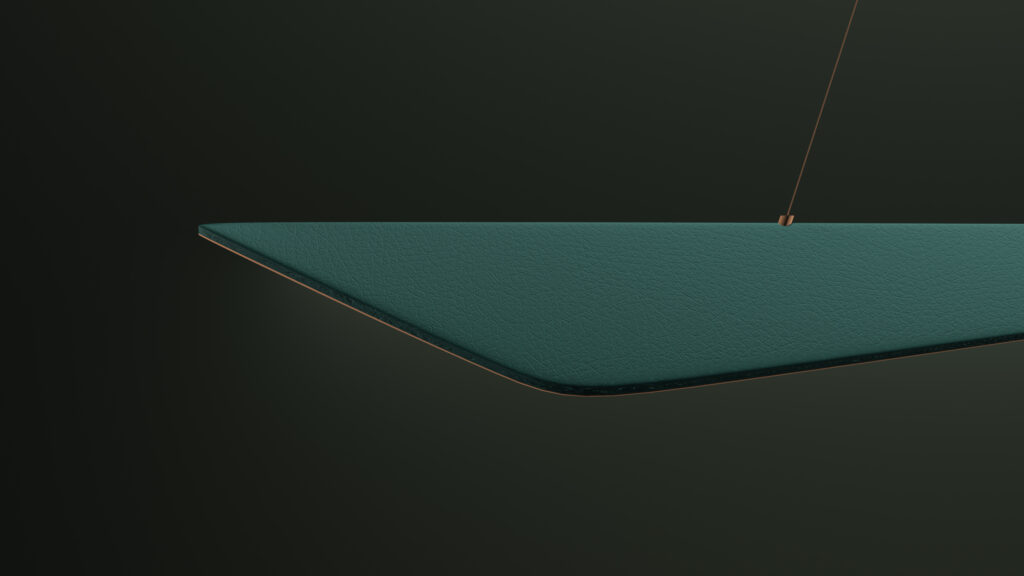 A close-up of the Folio Pendant Light reveals its minimalist, triangular form with a textured green finish reminiscent of luxury game tables, suspended by a thin cord against a dark green background.