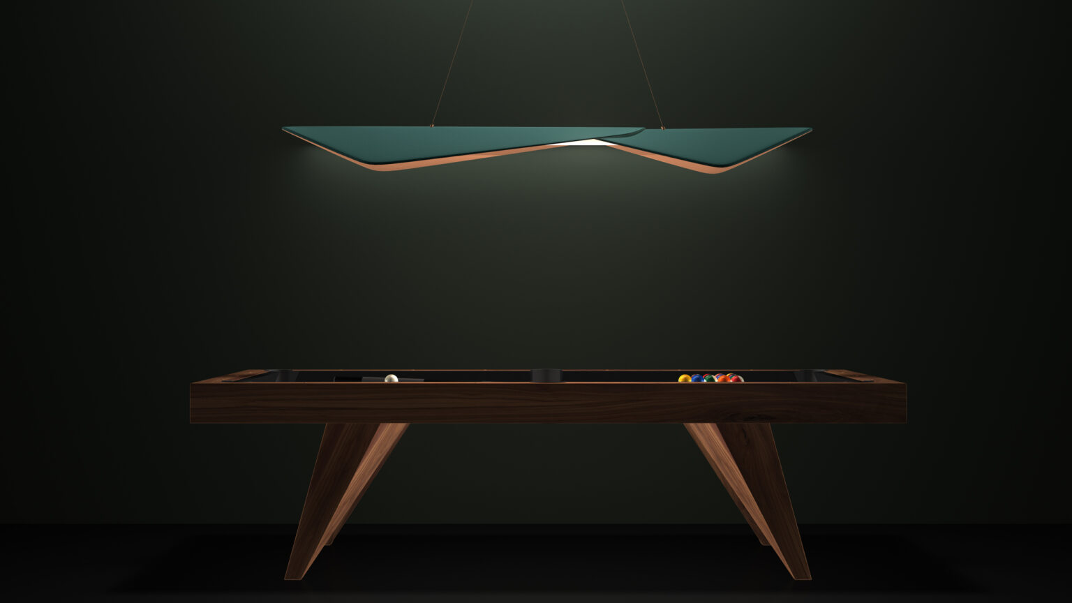 The modern luxury game table with a dark wooden frame is set against a deep green wall. Above, the sleek Folio Pendant Light hangs, casting a soft glow on the table where a cue ball and colored balls are arranged.