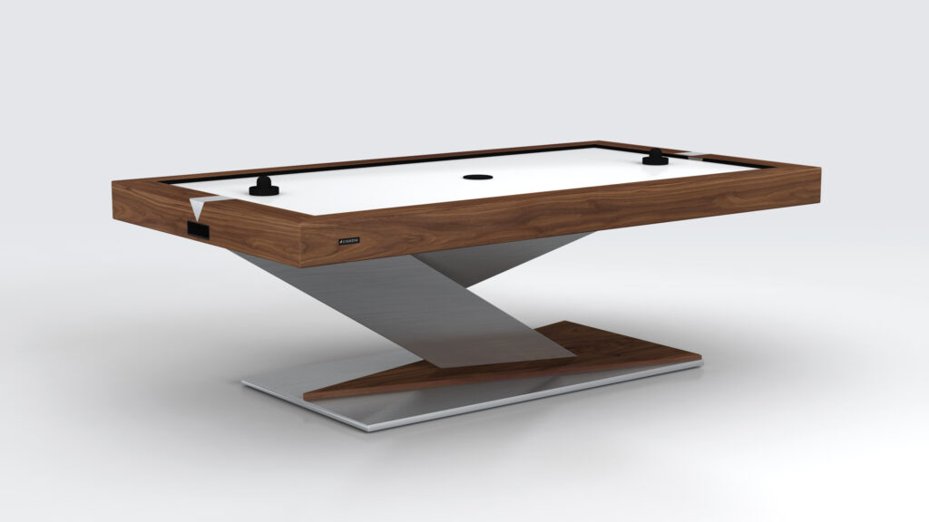 The Mitchell Air Hockey Table is a luxurious, modern game table with a sleek design, featuring a wooden frame and metal base. It includes a puck and two strikers on its pristine white playing surface.