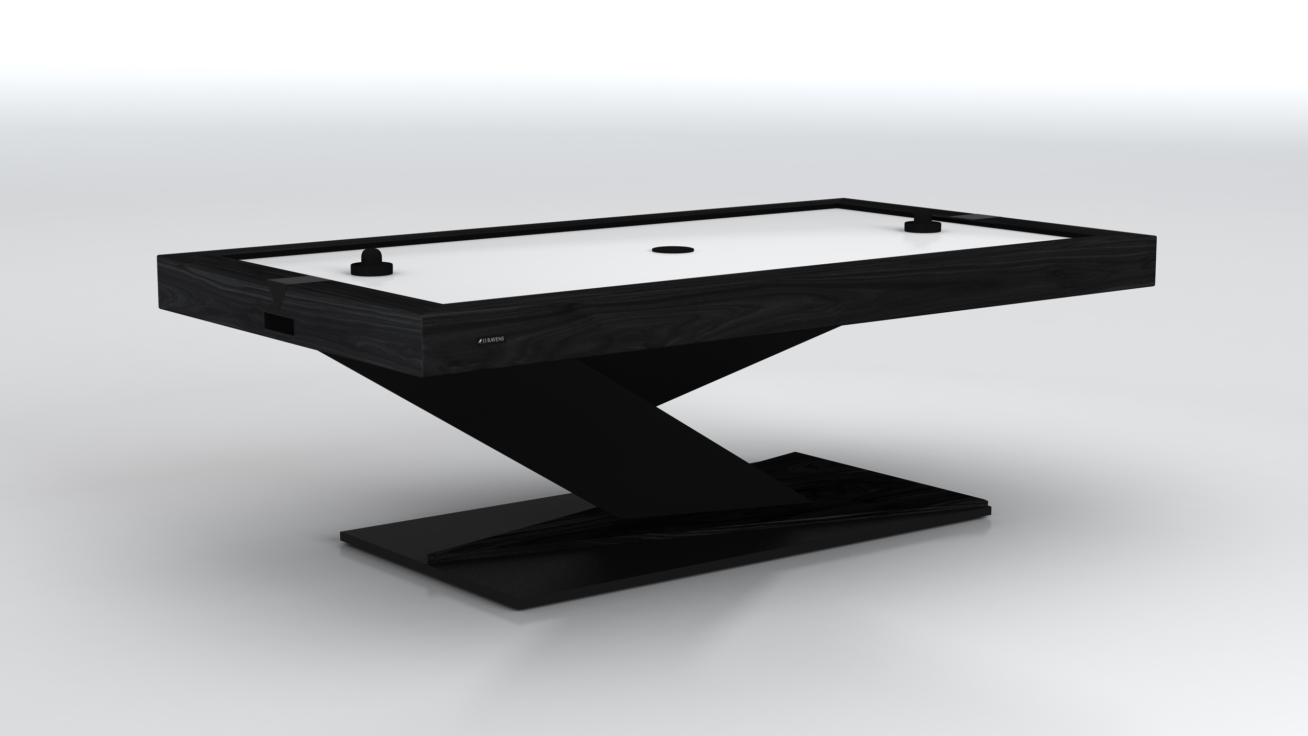 The Mitchell Air Hockey Table features a sleek, angular base and minimalist design. Shown against a plain white background with two pushers and a puck on its smooth white playing surface.