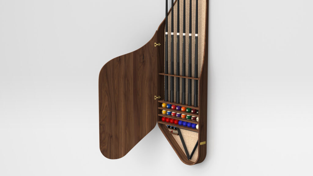 A wall-mounted wooden cabinet with an open door reveals a vertical space dedicated to the Rubinacci Pool Table. Inside, billiard cues and multi-colored billiard balls are neatly arranged in compartments, ready for play.
