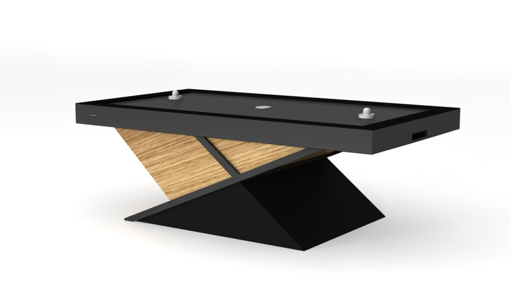 The Macan Air Hockey Table is a modern luxury game table with a sleek black and wood design, featuring a unique slanted base for support. It comes with two mallets and a puck on the playing surface.