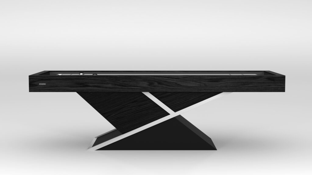 The Macan Shuffleboard Table boasts a modern black design with a sleek rectangular top and unique inverted triangular base, featuring white accents. Its minimalist style, reminiscent of luxury game tables, stands out against the plain light gray background.