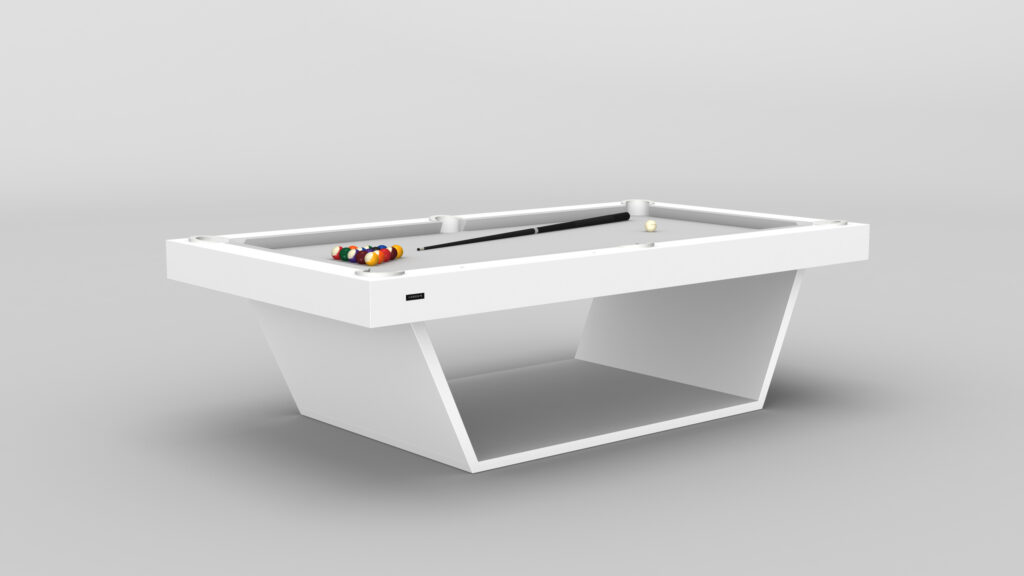 The Mesa Pool Table - Quick Ship features a modern, minimalist white design with clean lines and a sleek geometric base. Colorful billiard balls and a cue ball are elegantly arranged on its black felt surface, set against a plain light gray backdrop.