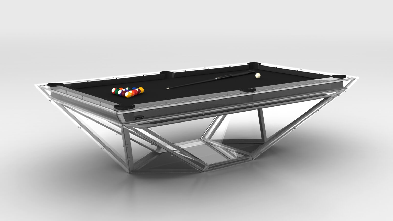 The Stealth Lucite Pool Table features a sleek, transparent frame with a black surface. Pool balls are arranged on one side, and a cue stick rests diagonally across it. A plain light gray background highlights the tables elegant design.