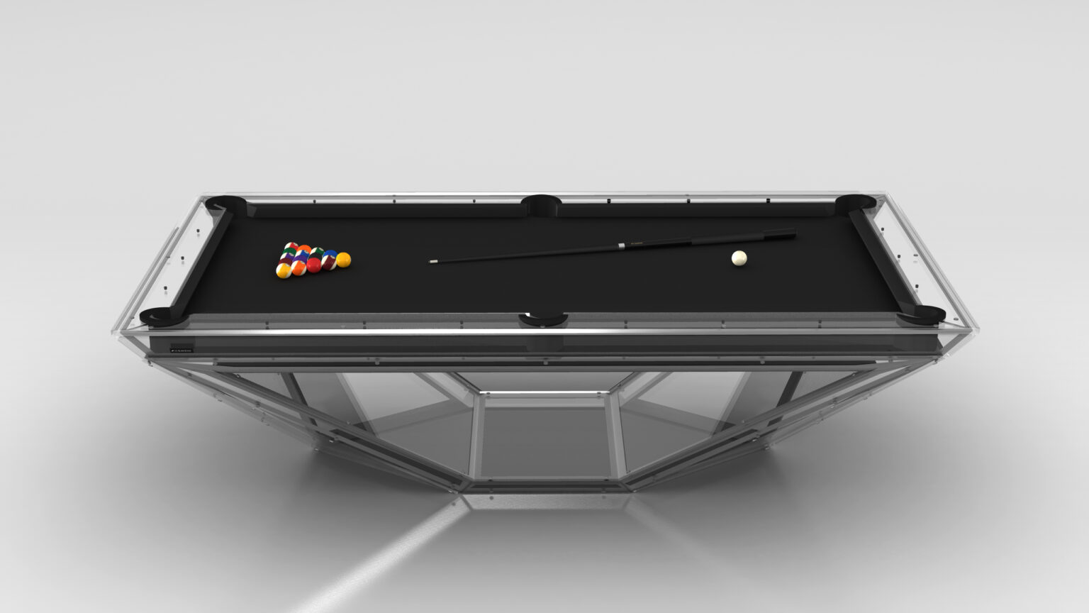 The Stealth Lucite Pool Table is a modern luxury game table with a sleek glass frame and black felt top, hosting a set of colored billiard balls racked in a triangle, accompanied by a cue stick and the classic white cue ball.