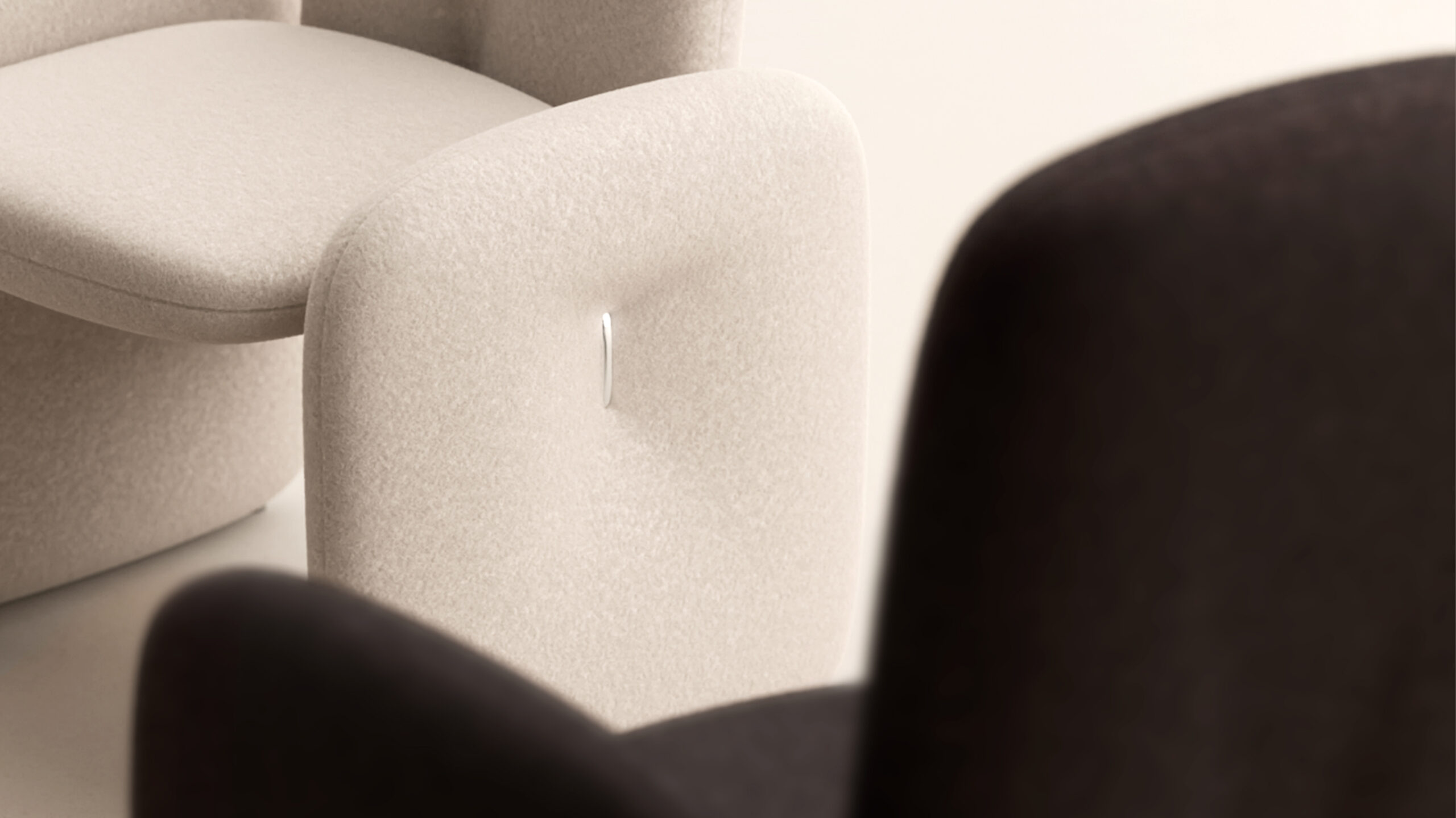 Close-up of two modern upholstered armchairs, one cream with a tufted button and one dark brown, beside the Cena Dining Table—showcasing soft curves and minimalist design.