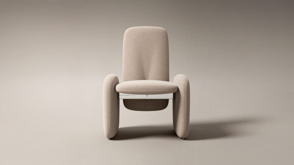 A modern beige armchair with rounded edges and three oval legs sits centered on a light gray background, styled next to the Cena Dining Table, with a white book placed under the seat.