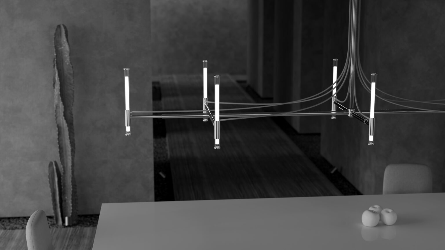 A modern, minimalist room showcases the Cena Dining Table with two chairs and a small centerpiece, paired with a sleek linear chandelier, a tall cactus in the corner, and moody dark-toned décor.