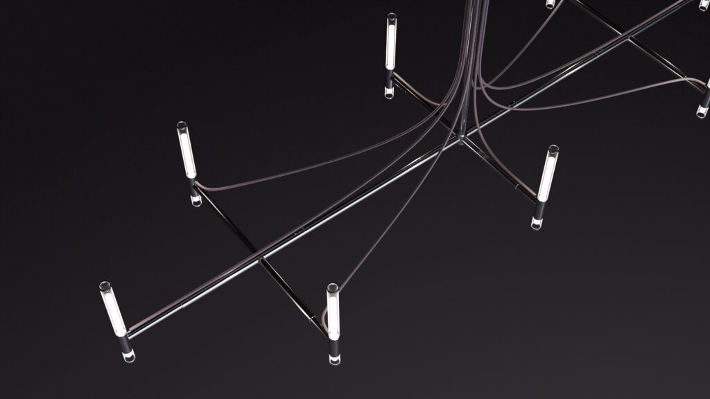 A striking geometric ceiling light with intersecting metal rods and cylindrical LED lights, suspended by thin cables above the Cena Dining Table, creates a bold abstract look against a dark background.