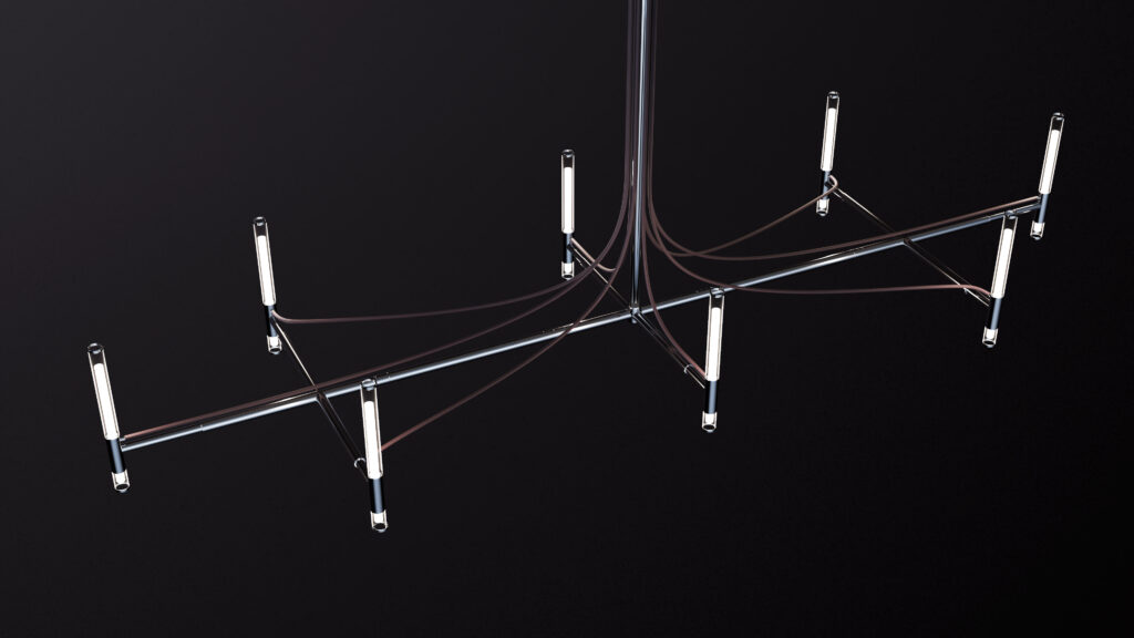 Suspended above the Cena Dining Table, this chandelier’s sleek metallic frame and eight tube-shaped LED lights create a modern, minimalist centerpiece against a dark backdrop.