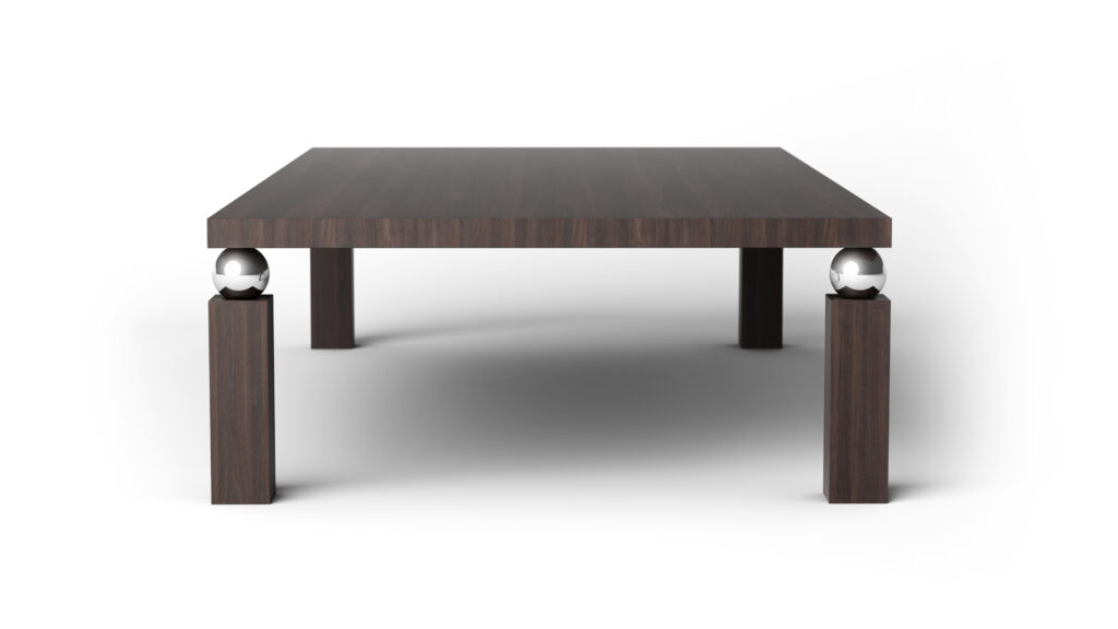 The Cena Dining Table is a low, rectangular table made of dark wood with thick legs, each accented by a shiny metallic sphere near the top, displayed against a simple white background.