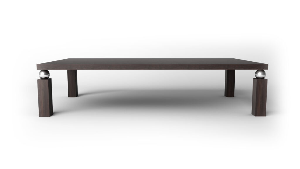 The Cena Dining Table is a modern rectangular table with a dark wood finish and four legs, two accented with shiny metallic spheres, displayed against a plain white background.