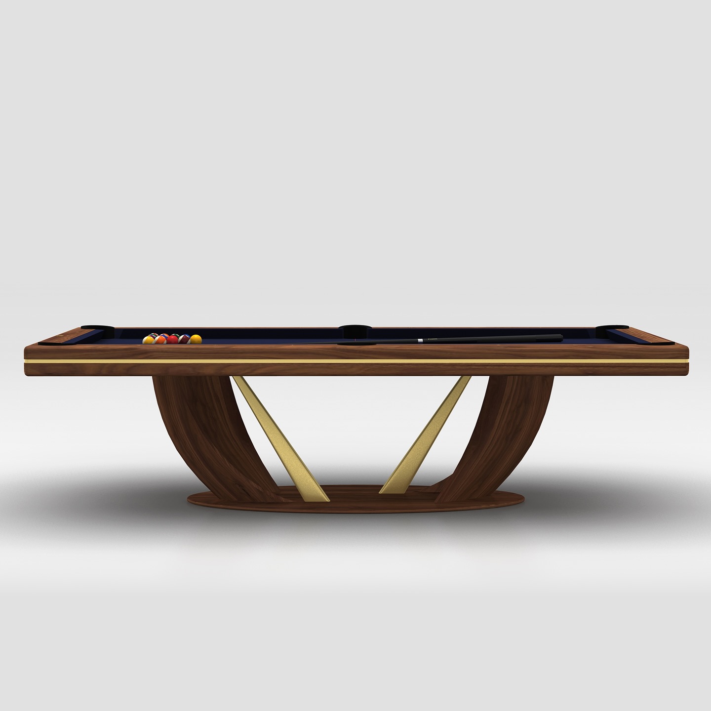 A modern pool table with a dark wood finish, gold accents, and a unique curved base. The tabletop has pool balls and cue sticks arranged, set against a plain light gray background.