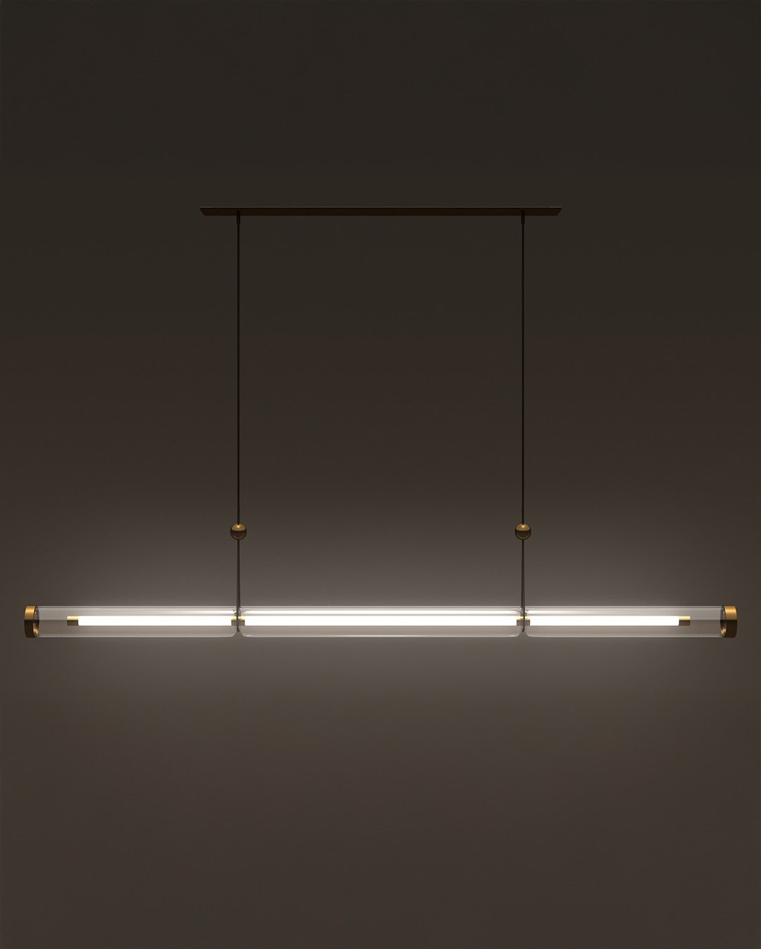 A minimalistic, horizontal pendant light with a slim, tubular design hangs from the ceiling by two thin cables, emitting a soft white glow against a dark background.