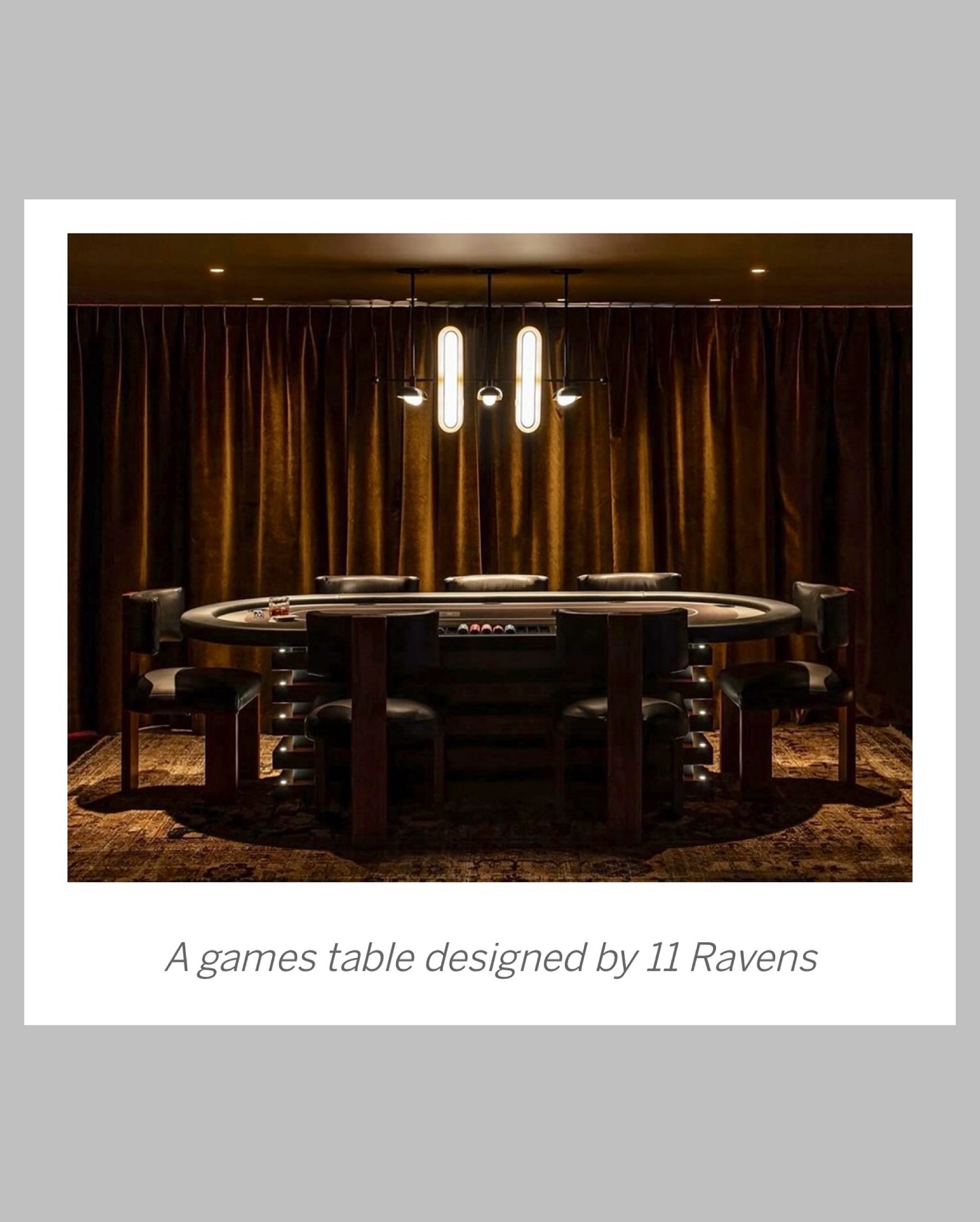 A luxurious round games table with cushioned chairs, soft lighting from a modern chandelier above, and rich brown curtains in the background. Text reads: A games table designed by 11 Ravens.