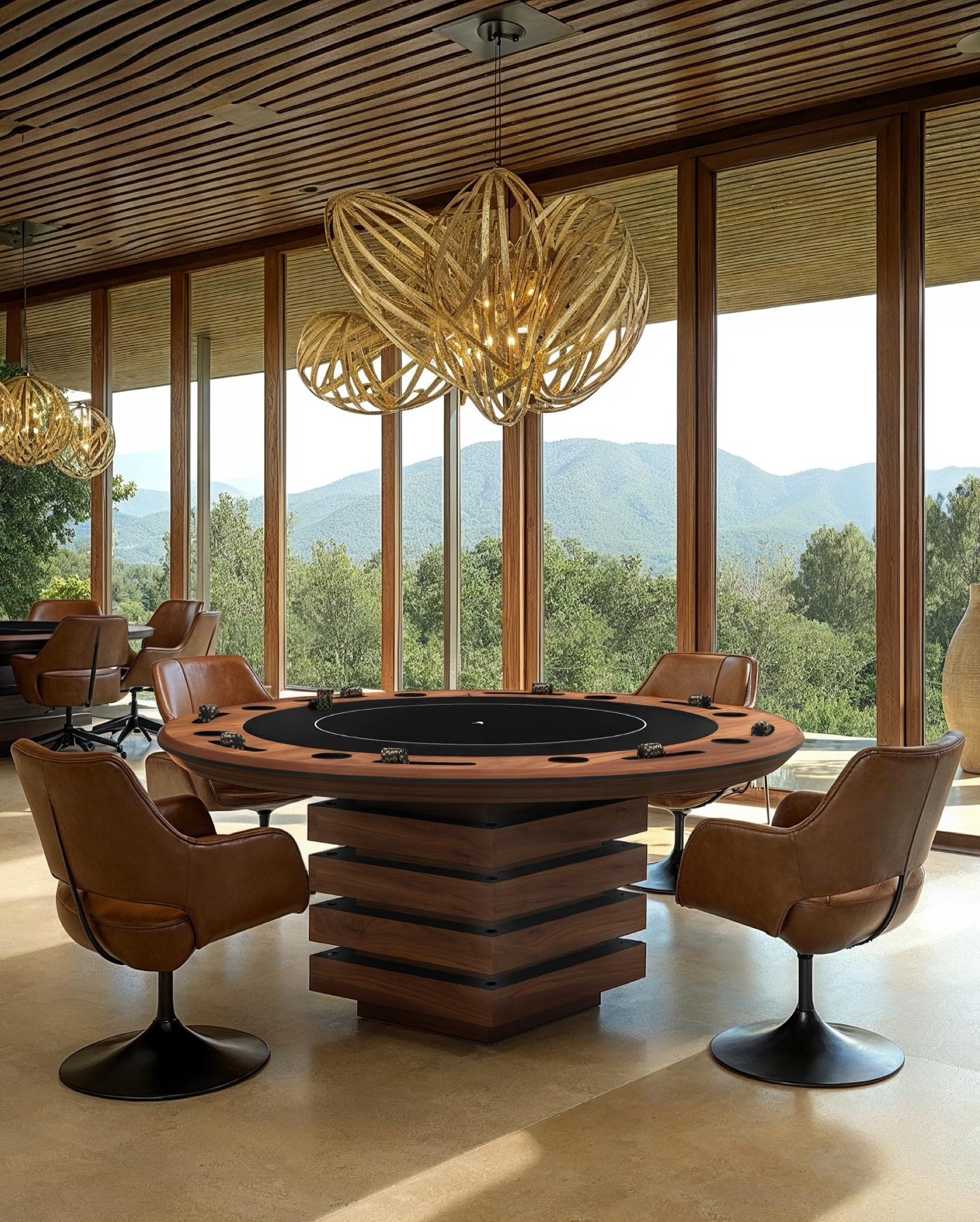 A modern poker table with brown leather chairs sits in a stylish room with large windows, offering scenic views of green hills and trees. Contemporary pendant lights hang from a wooden ceiling above the table.