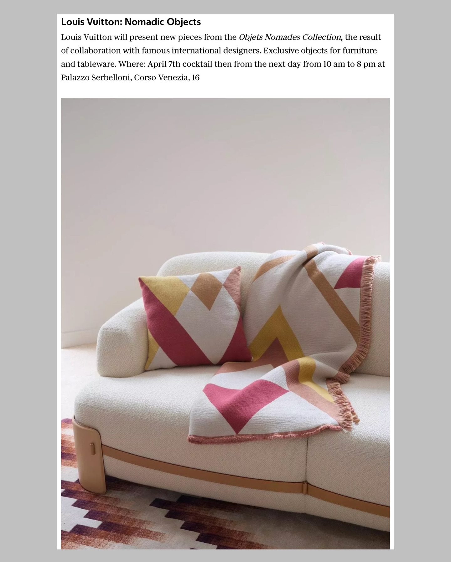 A modern white sofa with two geometric-patterned cushions and a matching throw blanket in pink, beige, and mustard colors, set against a neutral background.