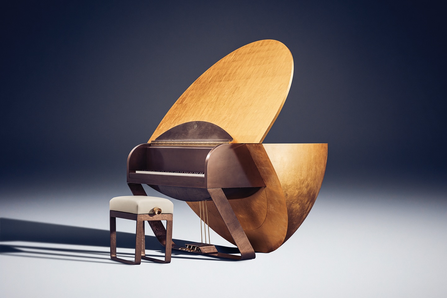 A unique, modern piano with a large, semi-circular wooden back and sleek, angular legs sits on a plain surface. A matching stool with a cushioned top is placed in front of the piano.