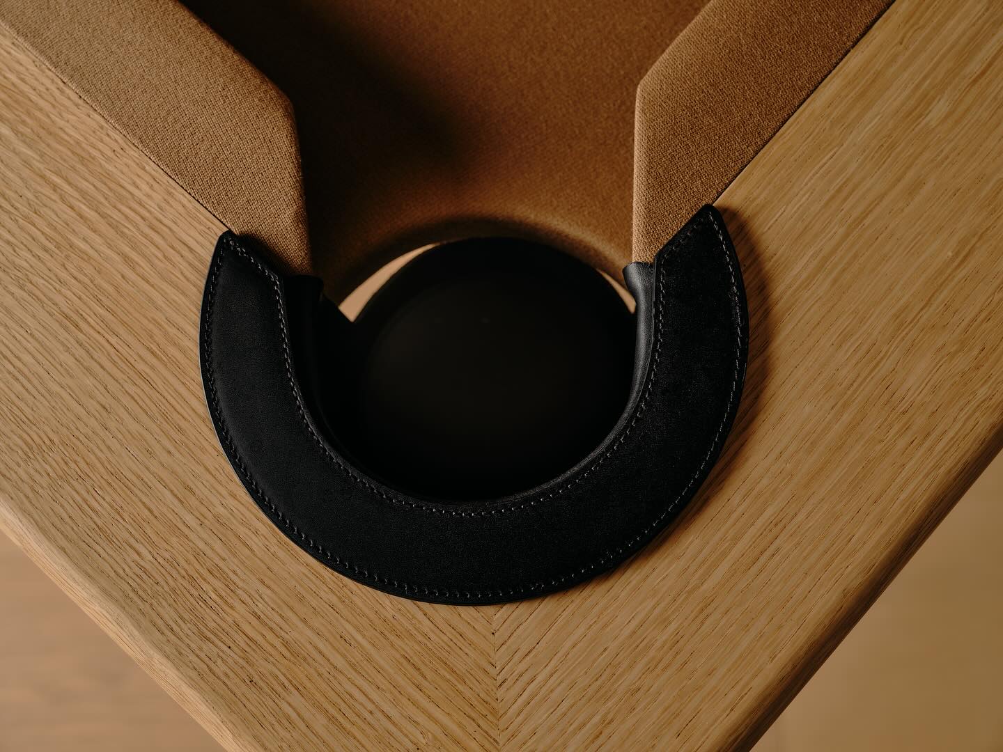 Close-up of a corner pocket on a bespoke convertible game table, featuring tan felt and a black leather pocket liner—an elegant detail any interior designer would appreciate.