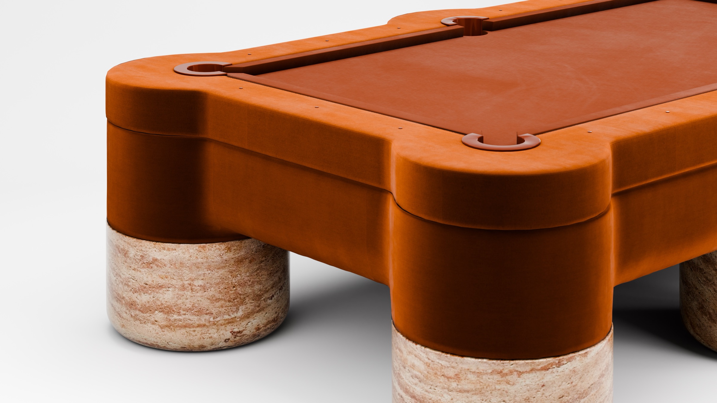 The Marc Ange Pool Table features rust-colored felt and frame with thick cylindrical stone legs, crafted in collaboration with 11 Ravens, and is displayed against a plain white background.