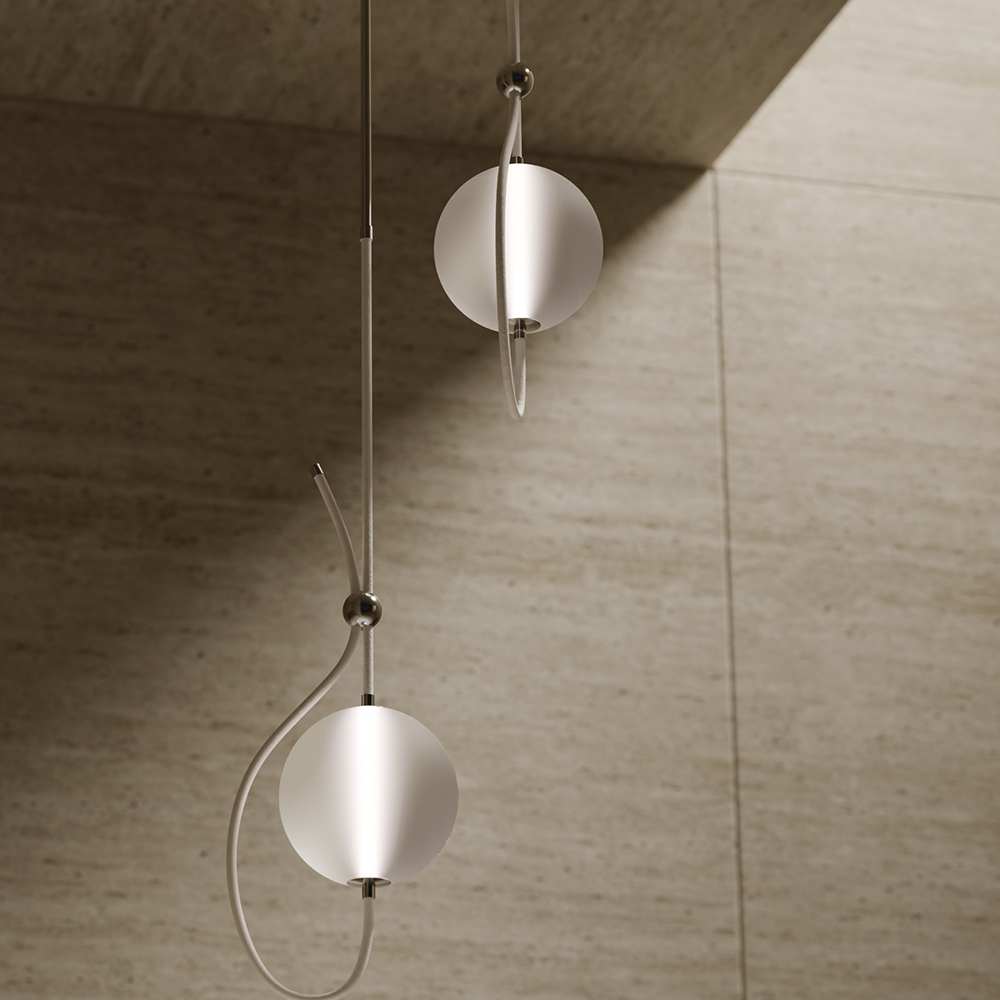 Two modern pendant lights with frosted glass globes and thin metallic rods glow softly against a beige textured wall, creating a serene ambiance—perfect for elevating your living room with 11 Ravens-inspired style.