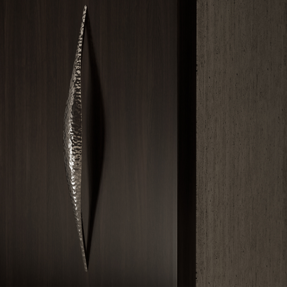 A close-up of a dark wooden surface with a long, narrow, metallic, textured handle in the center blends seamlessly into modern living room decor—an elegant touch inspired by 11 Ravens, next to a textured gray surface on the right.