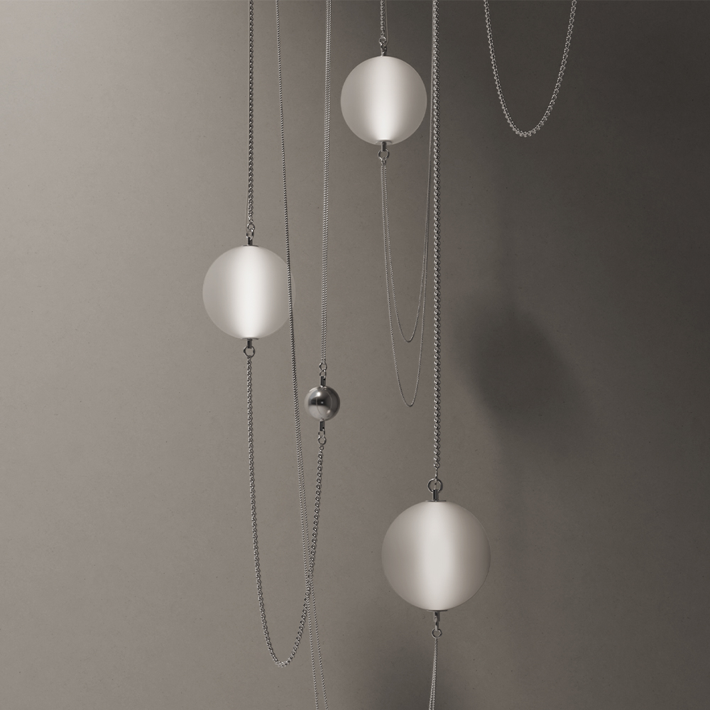 Minimalist composition with four frosted glass spheres and one small metallic sphere suspended on thin silver chains against a neutral, softly lit background—an elegant, contemporary statement perfect for any modern living room.