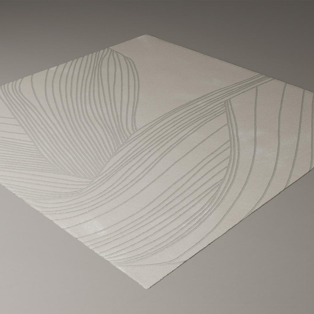 A square, light-colored rug with an abstract, curved line pattern in a slightly darker shade, perfect for adding modern style to your living room. Featured on a plain surface, this design pairs seamlessly with 11 Ravens furnishings.