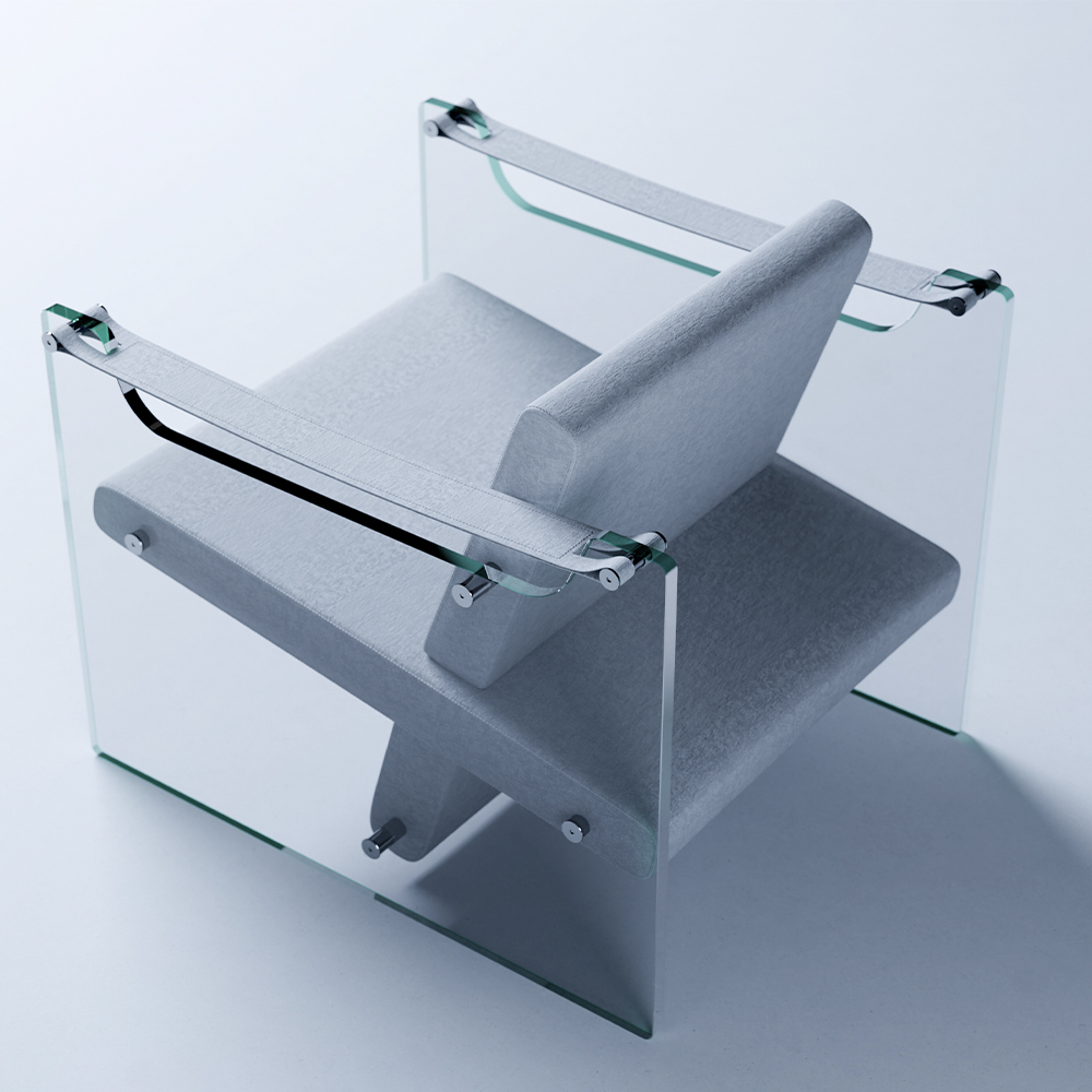 A modern armchair with a geometric design, perfect for any living room, featuring a grey cushioned seat and backrest, transparent glass sides, and metal accents on the armrests, set against a light background. Designed by 11 Ravens.
