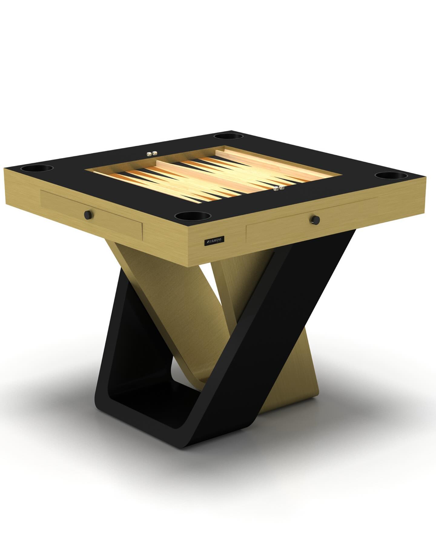 A modern, square backgammon table with a gold playing surface and black trim, featuring a sleek, angular base and built-in cup holders at each corner.