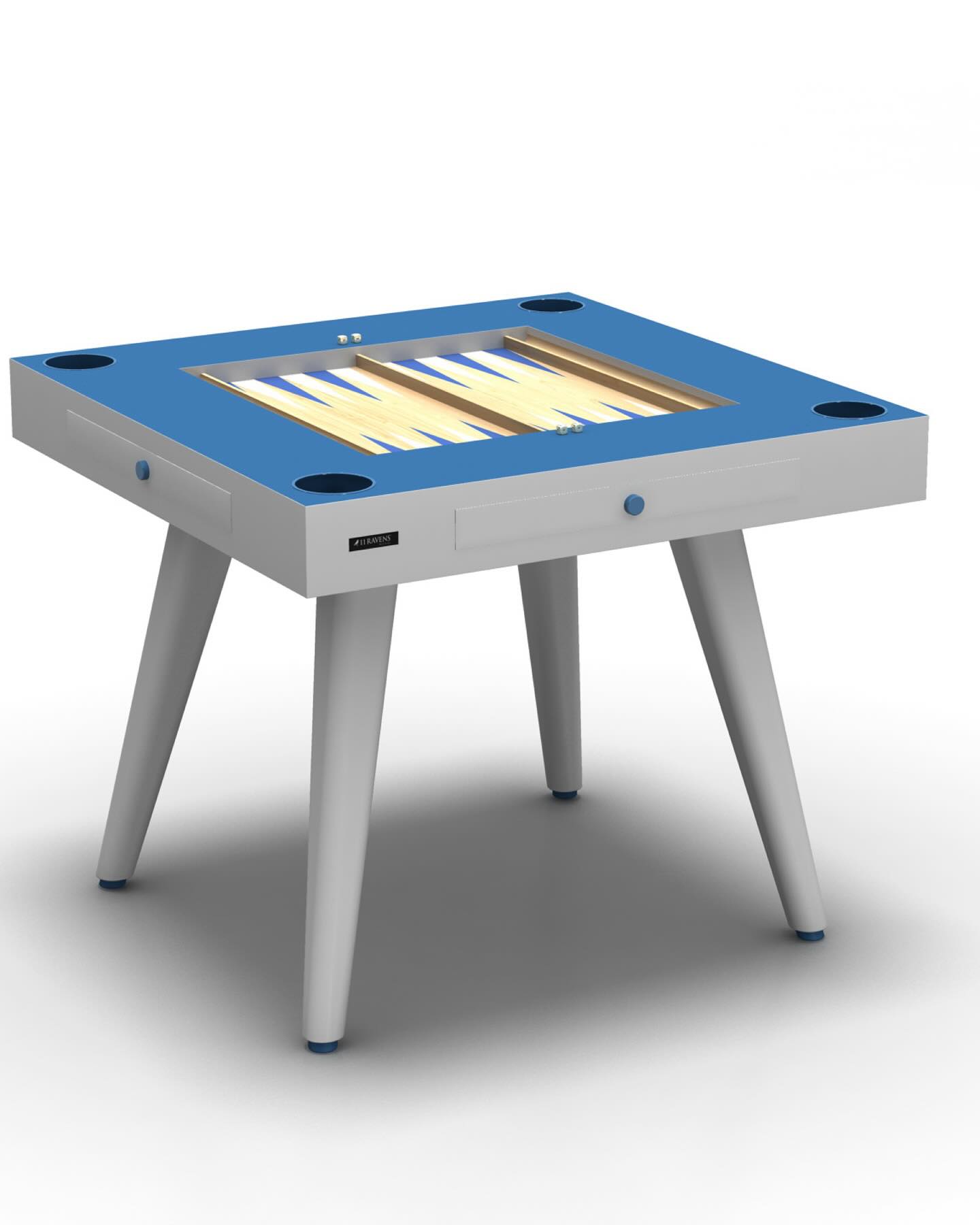 A modern, square backgammon table with a blue surface, white legs, cup holders at each corner, and a built-in backgammon board visible on top. The design is sleek and minimalist.