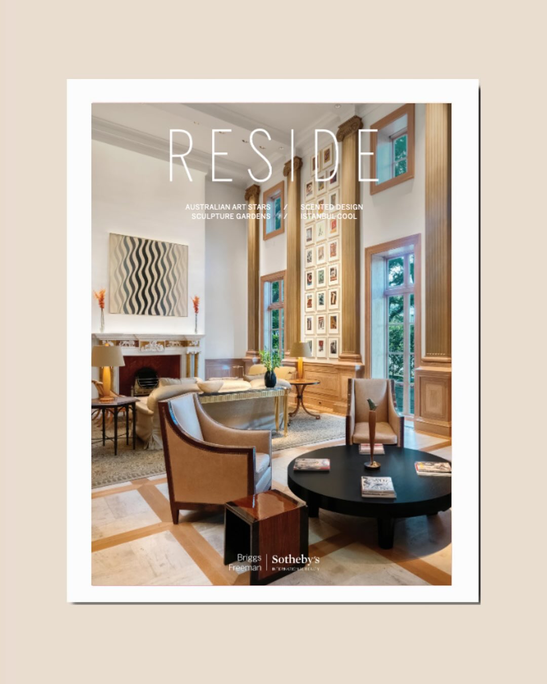 Cover of RESIDE magazine featuring a luxurious, elegant living room with high ceilings, tall windows, modern art, plush seating, and a coffee table on a patterned rug. The Sotheby’s logo is at the bottom.